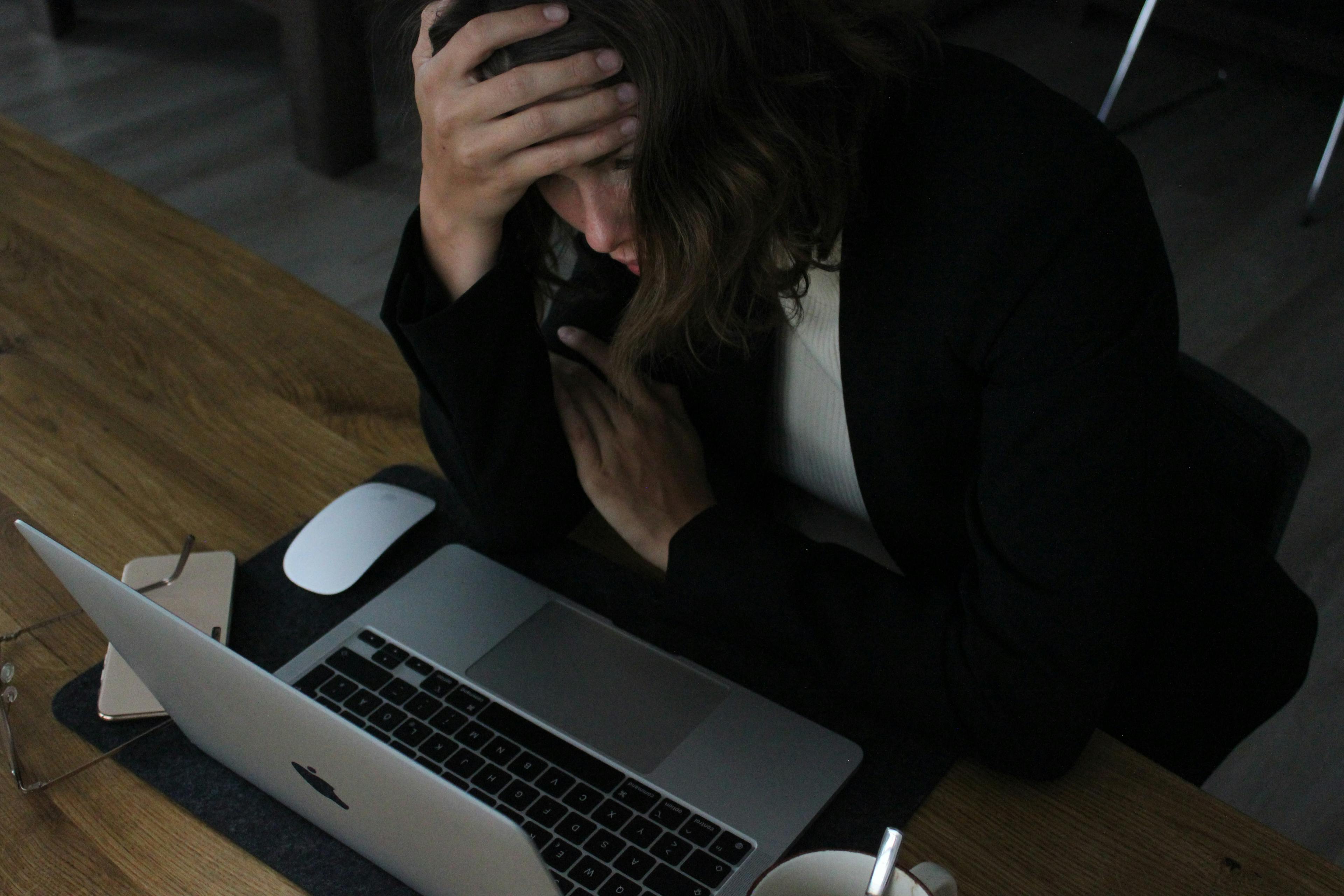 Distressed woman in front of laptop